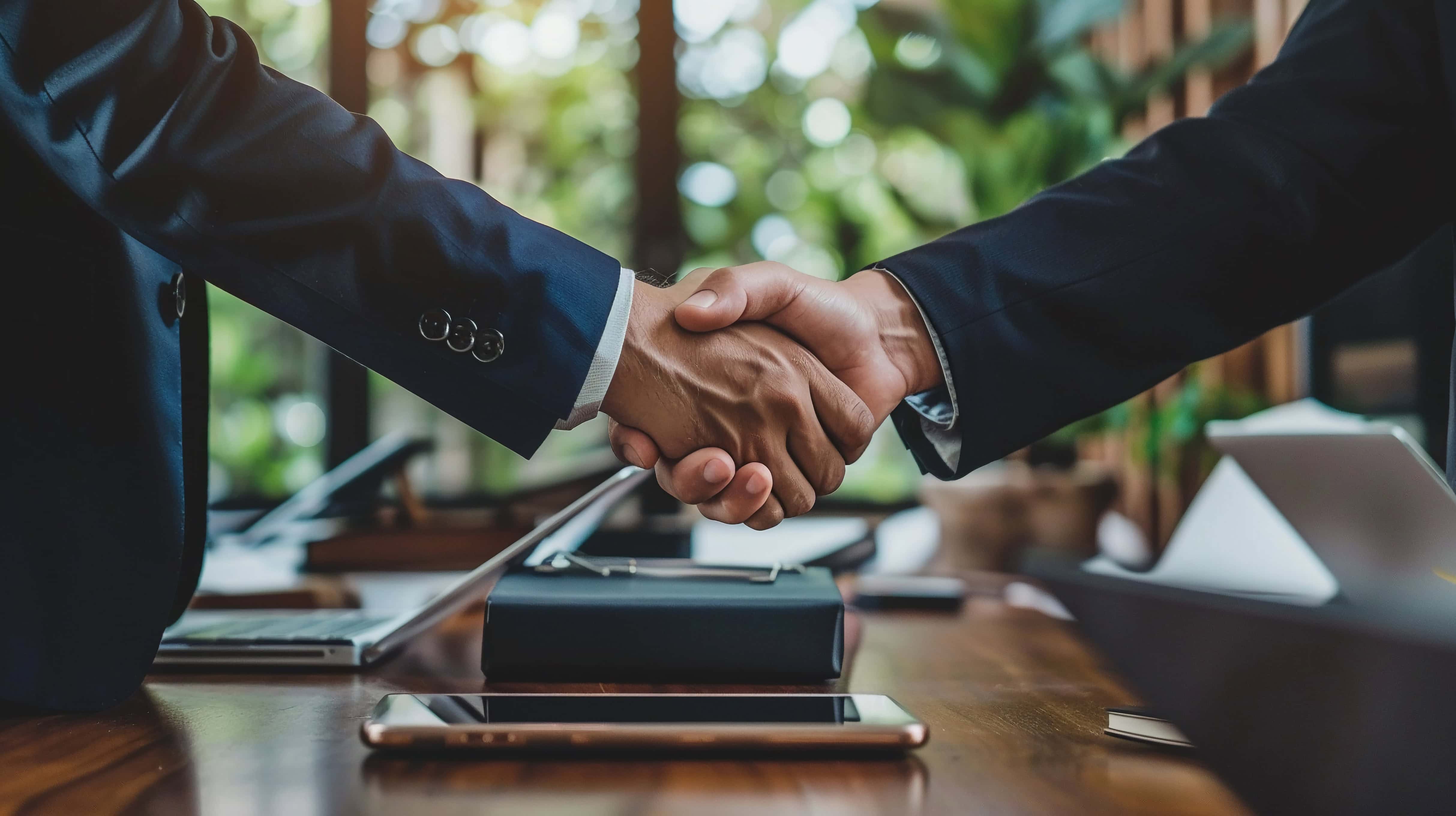 Business professionals shaking hands during a partnership meeting